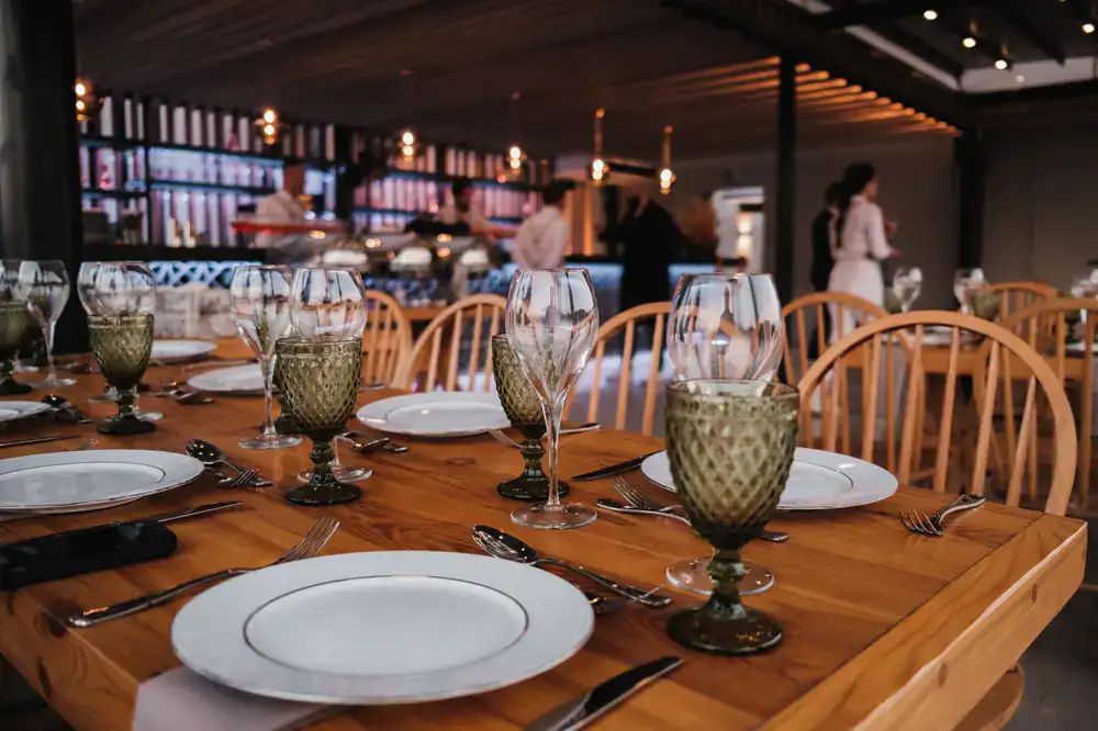 Guests laughing around a dinner table
